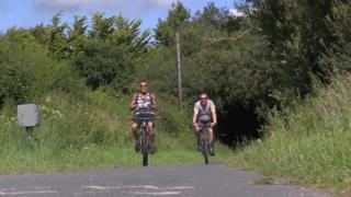 Two men cycling on a stretch of the Tarka Trail