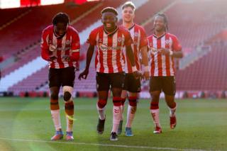 Kazeem Olaigbe (centre) celebrates scoring or Southampton's Under-23 side