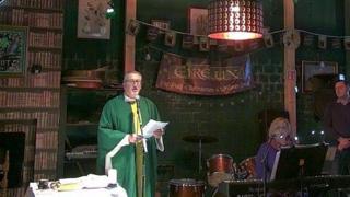 Father Michael Cusack holding mass in Luxembourg pub