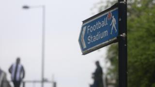 Signpost towards football stadium
