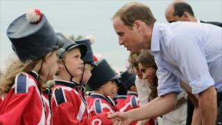 Prince William, the Duke of Cambridge, greets a group of children during a visit to Fort Levis in Levis, Quebec