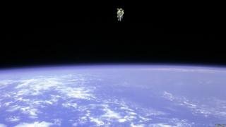 Astronaut on a space walk with Earth below him