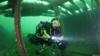 Diver Derek Haslam in a shipwreck