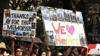 Harry Potter fans hold up signs ahead of the London premiere