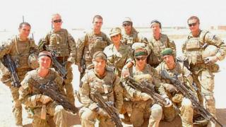 Cheryl Cole poses with British troops in Afghanistan