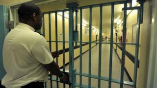 Prison officer locks a prison door