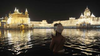 A Sikh man prays outside the Golden Temple in Amritsar, India.