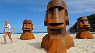 Heads up sculpture on beach in Sydney