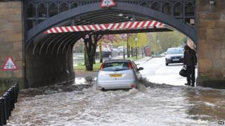Car drives through flood water in York