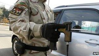 An Iraqi soldier using a 'bomb detecting' device at a checkpoint in Baghdad on January 23 2010