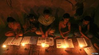 Muslim girls study in the light of candles inside a madrasa or religious school during power-cut in Noida on the outskirts of New Delhi.