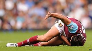 Andy Carroll lies in pain after sustaining an injury