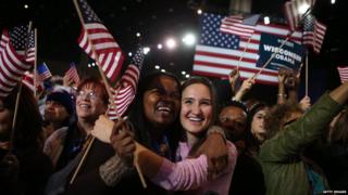 Supporters of US President Barack Obama cheer after networks project Obama as reelected