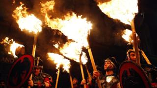 Up Helly Aa vikings from the Shetland Islands, hold lit torches during the annual torchlight procession to mark the start of Hogmanay.