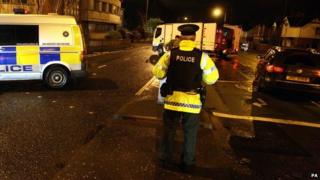 Police seal off a road in Belfast.