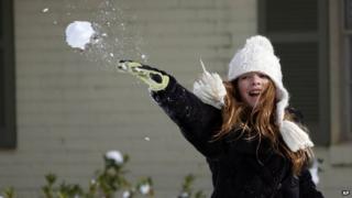 Girl throws snowball
