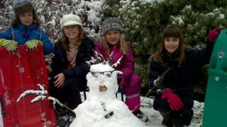 Four children and a snowman.