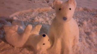 Two polar bears made of snow.