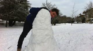 Ricky forms the base of his snowman.