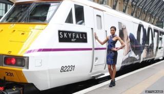 Bond girl Naomie Harris stands next to the train