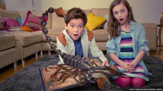 Children play with the Playstation's wonderbook.
