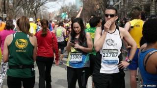 Runners reacting after explosions at the Boston Marathon