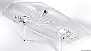 A glass table with a rippling water effect.