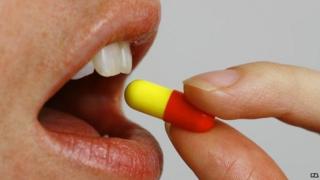 Person swallowing a pill