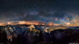 The photograph shows the Milky Way arching over Yosemite Valley in California’s famous national park.