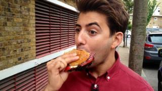 Newsround reporter Ricky Boleto eats a burger