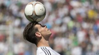 Gareth Bale balances a ball on his head