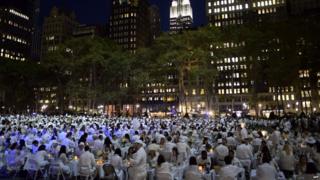 A park full of people dressed in white.