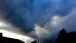 Undulating dark blue and grey cloud.
