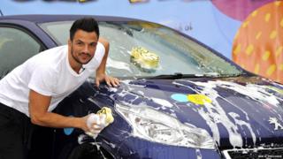 Peter Andre washes a car