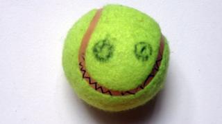 Tennis ball with face drawn on.