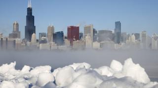 Chicago skyline can be seen through the arctic sea smoke rising off Lake Michigan
