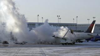 Plane is de-iced at Chicago airport.