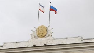 Crimea and Russia flags above parliament building