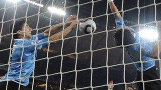 Uruguay's Luis Suarez handles the ball on the line against Ghana