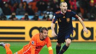 Andres Iniesta scores for Spain as Rafael van der Vaart of Netherlands looks on