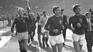 Bobby Moore and Geoff Hurst celebrate with the World Cup trophy in 1966