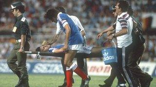 France's Patrick Battiston is stretchered off the pitch after being fouled by West Germany goalkeeper Harald Schumacher