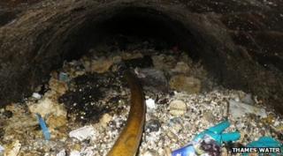 Tonnes of rubbish, congealed fat and wet wipes block a water pipe.