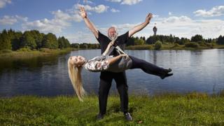 Man lifts woman with his beard