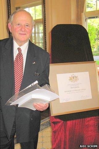 Frank Vajda next to a certificate making Raoul Wallenberg Australia's first and only honorary citizen.