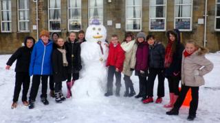 Snowman with schoolchildren