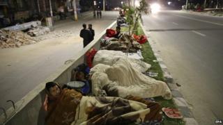 People sleep outside on a street a in Kathmandu, Nepal