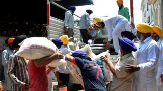 Volunteers in Amritsar, India, load a truck with food to send to quake survivors in Nepal