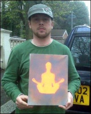 Joel Henson, pictured with a piece of his artwork
