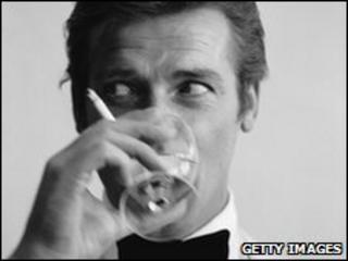 James Bond actor Roger Moore with a drink and a cigarette